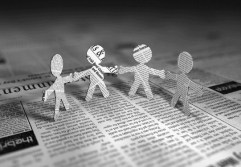 a few cut out figures made of newspapers